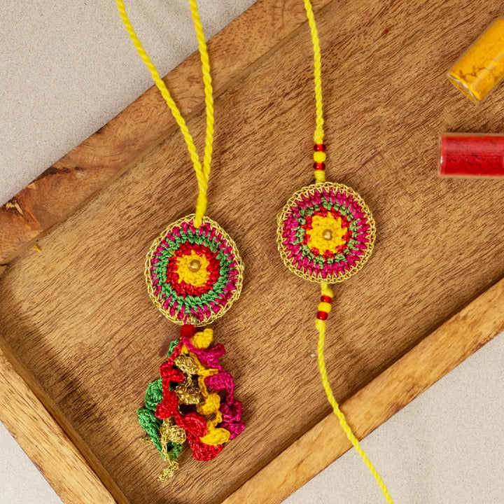 Handmade Crochet Rangeeli Bel Bhaiya Bhabhi Rakhi With Roli Chawal Set Of 2 - Close-up on Wooden Tray