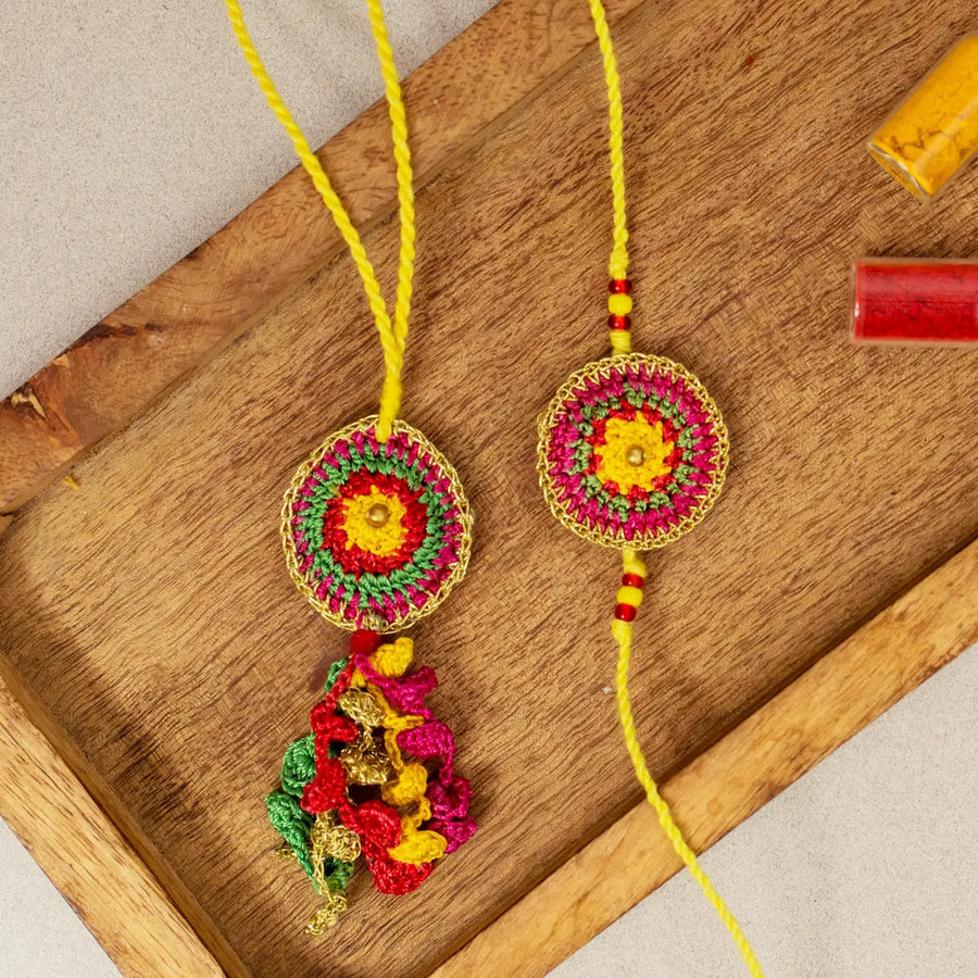 Handmade Crochet Rangeeli Bel Bhaiya Bhabhi Rakhi With Roli Chawal Set Of 2 - Close-up on Wooden Tray