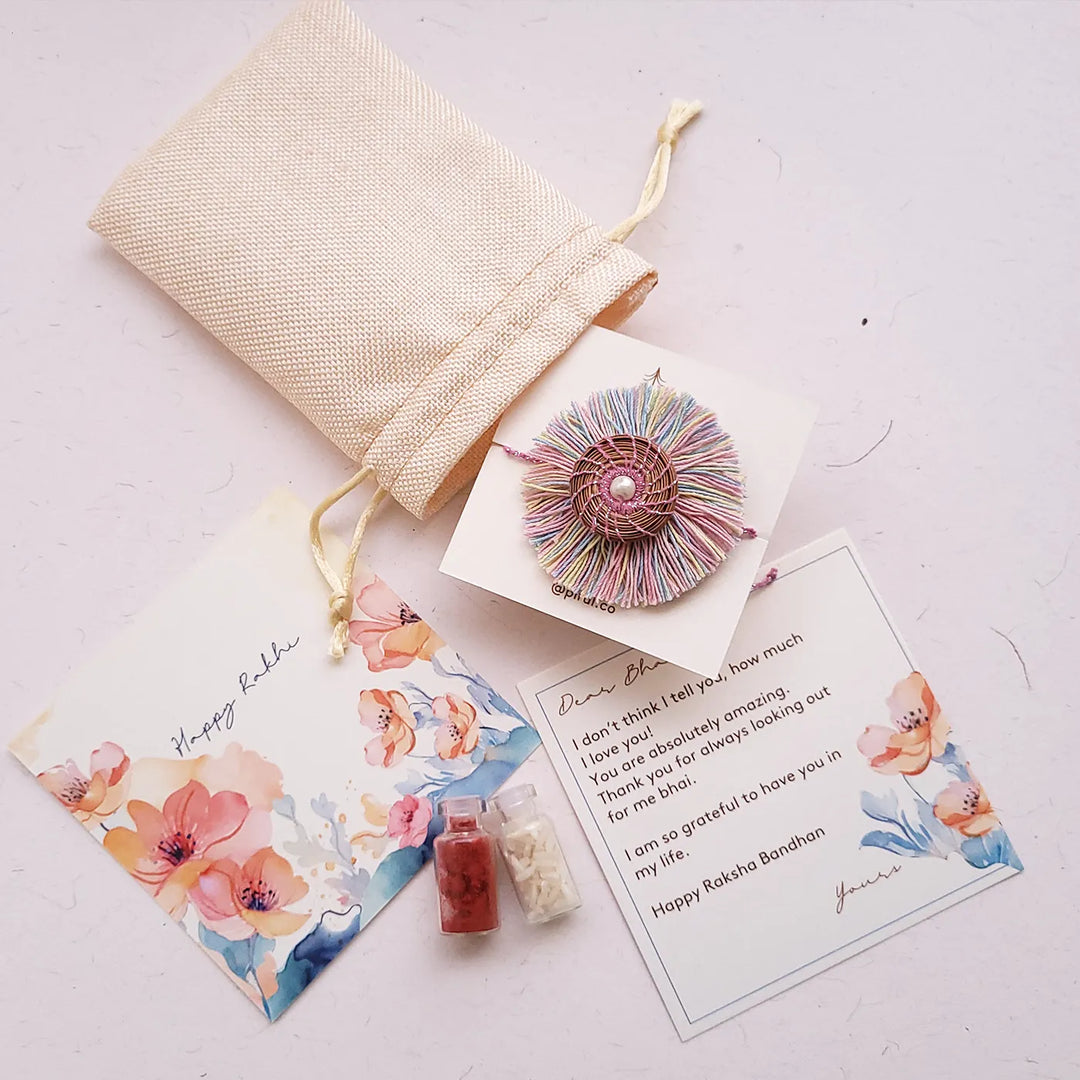 Eco Friendly Handmade Pastel Colour Pine Needle Rakhi With Pouch And Roli Chawal - Packaging with Greeting Cards