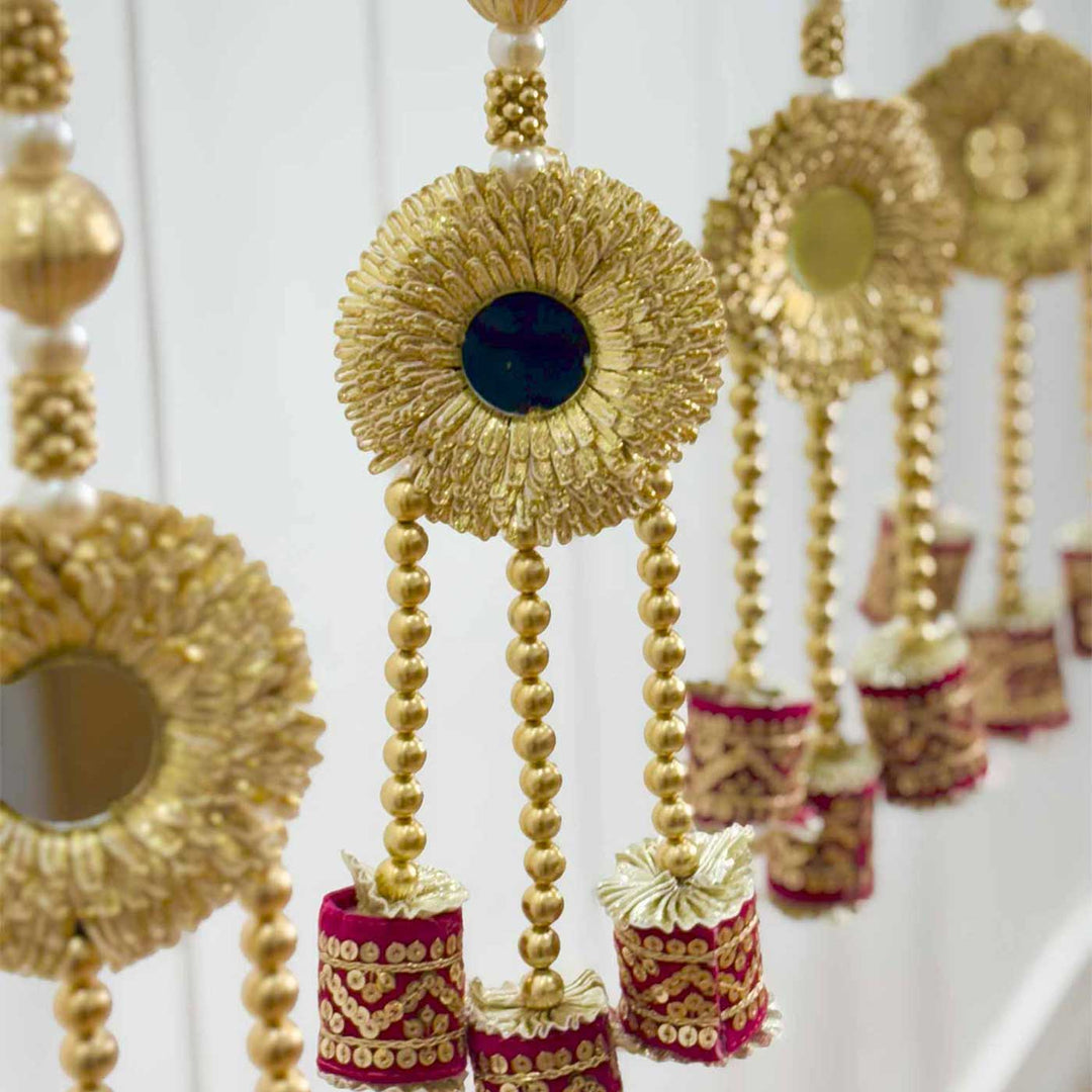 Handcrafted Maroon Cylindrical Tassels Door Hangings With Mirror, Bells And Gold Bead Detailing