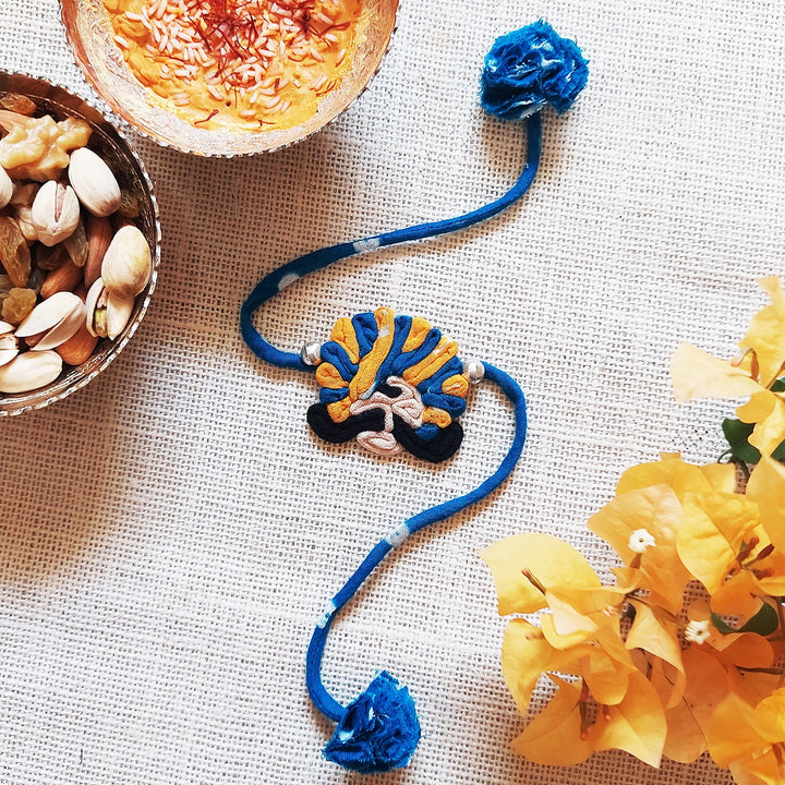 Handmade Dori Work Ethnic Rabari Rakhi With Roli Chawal - Decorative Blue Thread Bracelet Display