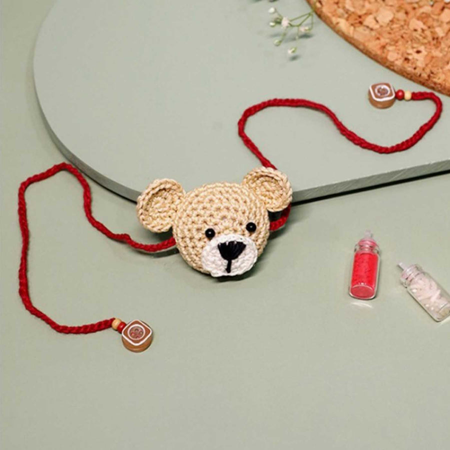 Handmade Crochet Teddy Hug Kids Rakhi With Roli Chawal - Front View with Red Thread