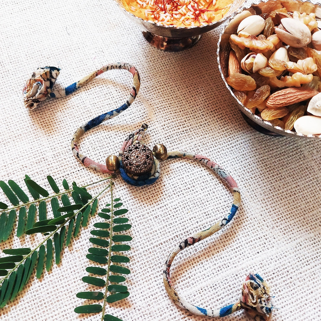 Handmade Dori Work Ambi Kalamkari Rakhi With Roli Chawal - Styled with Decorative Items
