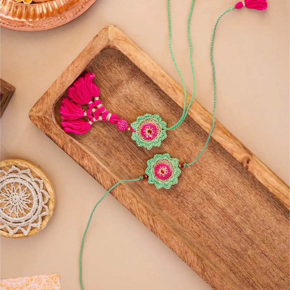Handmade Crochet Green And Pink Hariyali Bhaiya Bhabhi Rakhi With Roli Chawal Set Of 2 - Top Angle Product Layout