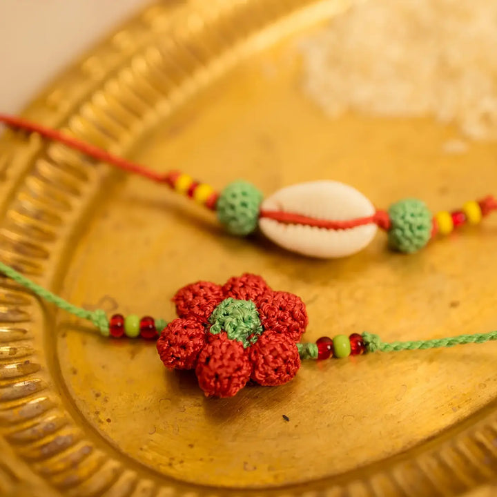 Handmade Crochet Phool Kaudi Rakhi With Roli Chawal Set Of 2 - Close-up showing handcrafted details