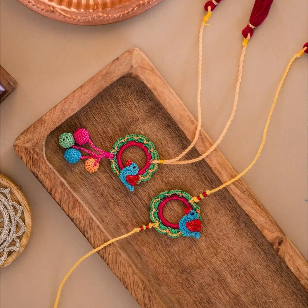 Handmade Crochet Sonchidiya Bhaiya Bhabhi Rakhi With Roli Chawal Set Of 2 - Top View with Background Items