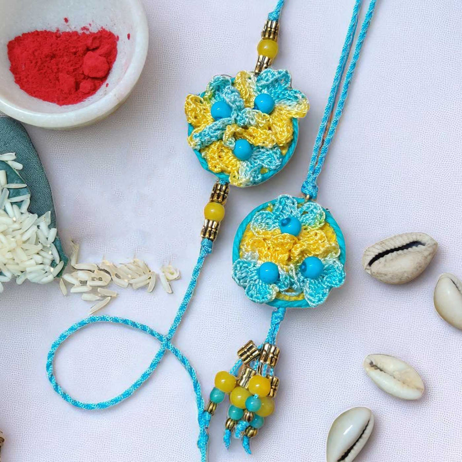 Handmade Crochet Beaded Flower Theme Cotton Rakhi With Roli Chawal For Bhaiya And Bhabhi - Close-up with Rice and Red Powder