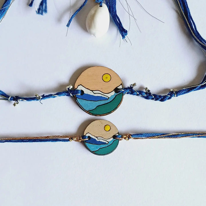 Handmade Blue Mountain Snow Design Ghungroo & Shell Wooden Bhaiya Bhabhi Rakhi With Roli Chawal