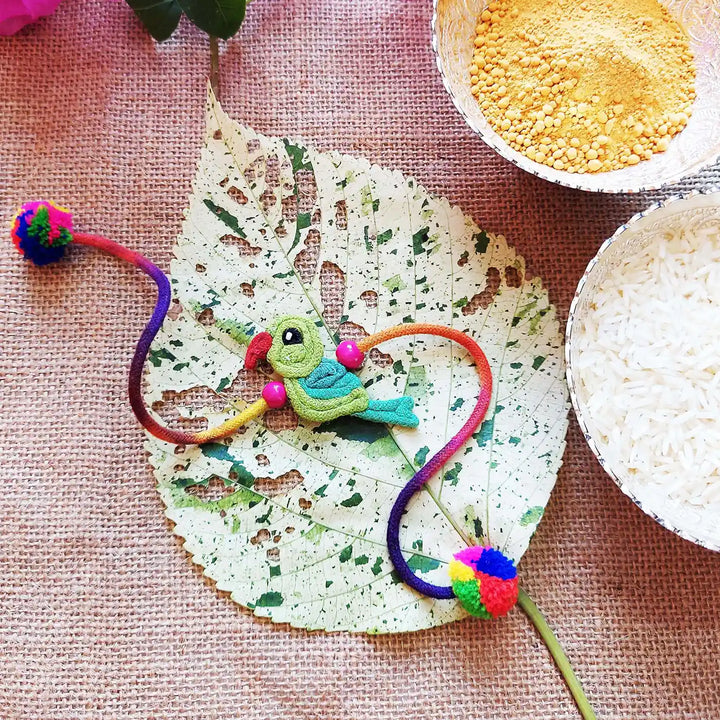 Handmade Dori Work Cute Parrot Kids Rakhi With Roli Chawal - Styled with Traditional Ingredients