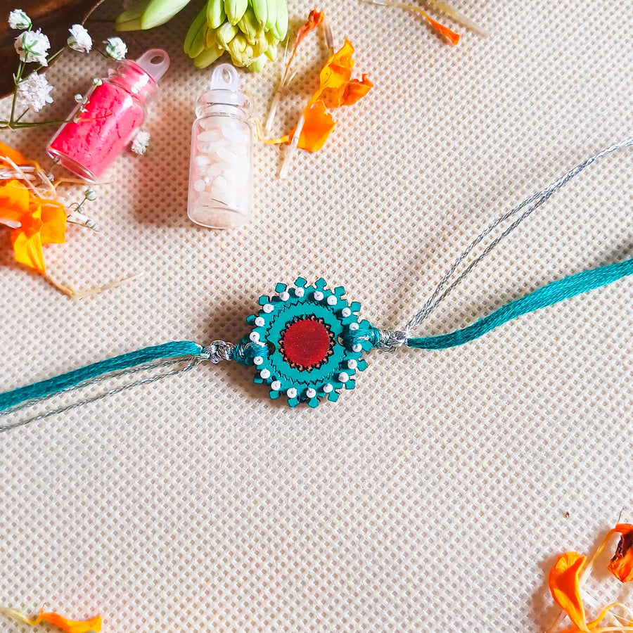 Handmade Turquoise Flower Shape Beads Wooden Rakhi With Roli Chawal For Brother - Flat Lay with Decorative Props