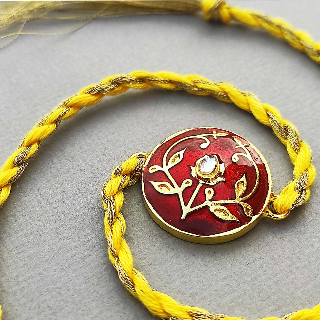 Handmade Meenakari Red Buta Brass Rakhi With Roli Chawal - Full View with Twisted Cord