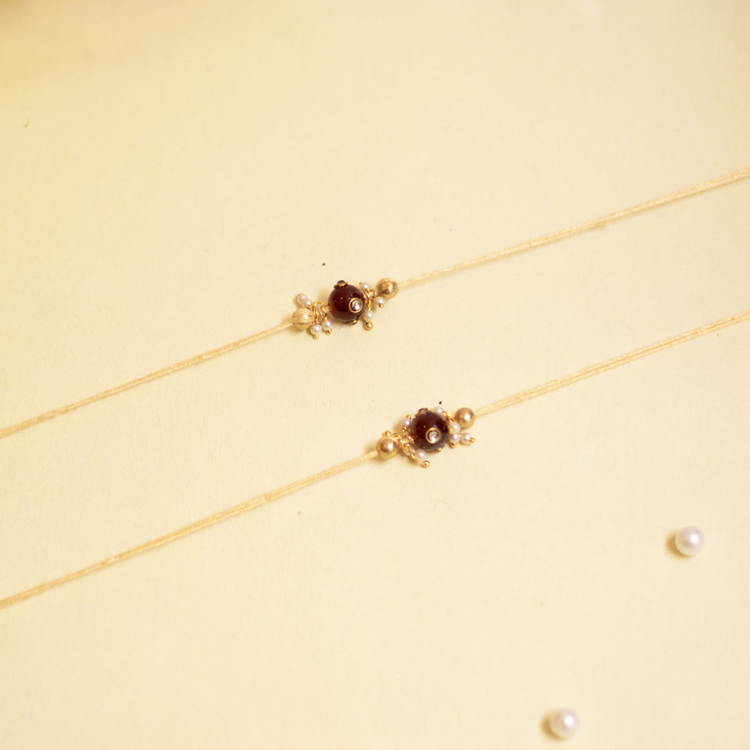 Handmade Red Manak Pearl Rakhi With Roli Chawal - Top View of Two Necklaces