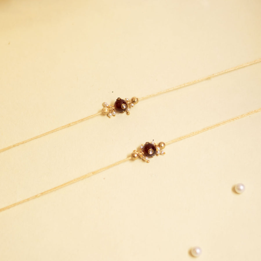 Handmade Red Manak Pearl Rakhi With Roli Chawal - Top View of Two Necklaces