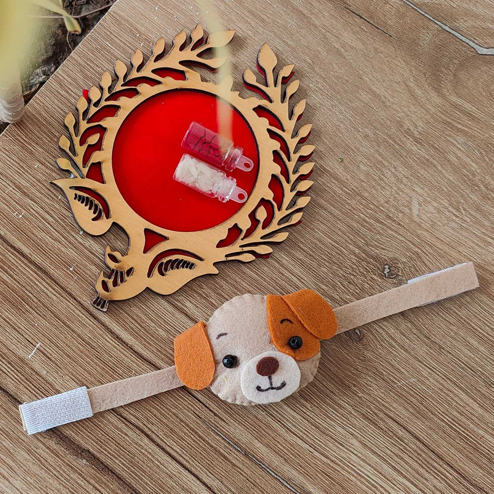 Handmade Dog Theme Felt Kids Rakhi With Roli Chawal - Flat lay with dog face accessory