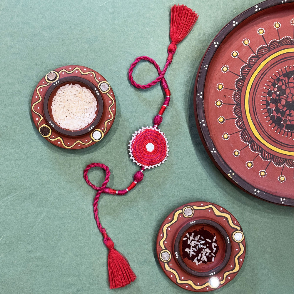 Handmade Reusable Pink Patwa Ari Mirror And Potli Rakhi For Brother - Styled with Decorative Bowls and Plate
