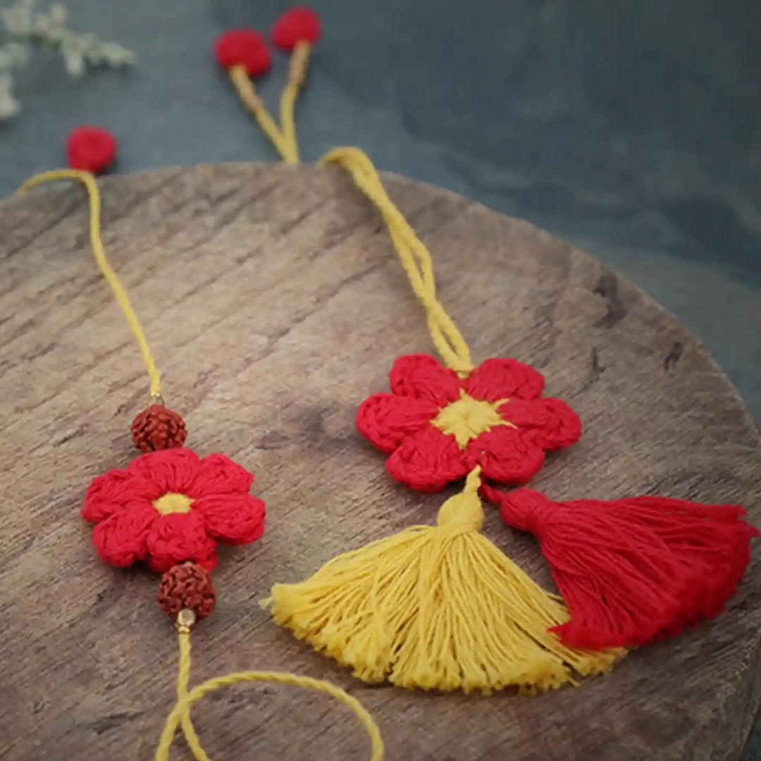 Handmade Crochet Red Flower Bhaiya Bhabhi Rakhi With Roli Chawal Set Of 2 - Close-up on Tassel and Flower Detail