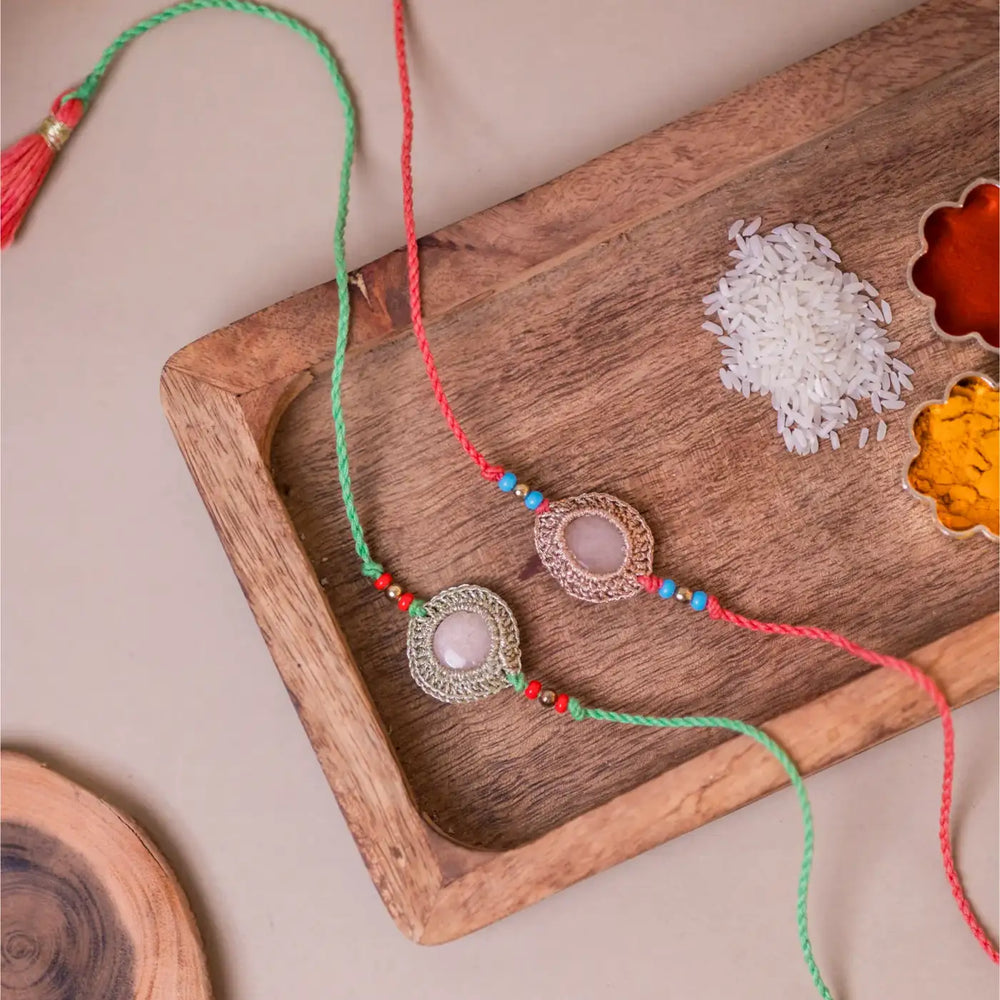 Handmade Crochet Moon Shine Rakhi With Roli Chawal Set Of 2 - Styled Flat Lay with Spices Tray