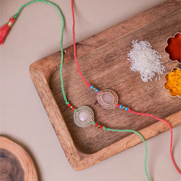 Handmade Crochet Moon Shine Rakhi With Roli Chawal Set Of 2 - Styled Flat Lay with Spices Tray