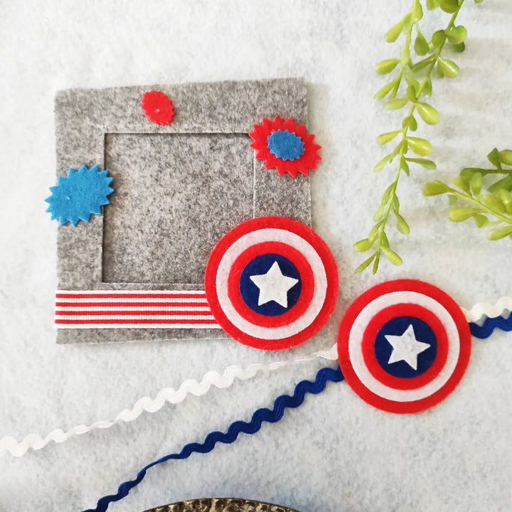 Photo Personalized Captain America Theme Felt Rakhi Hamper With Roli Chawal Includes 1 Magnetic Photo Frame 1 Rakhi - Flat Lay Display of Frame and Accessories