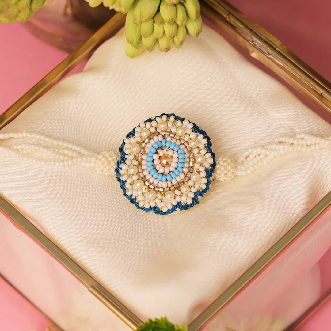 Handmade Beaded White & Blue Floral Rakhi With Roli Chawal