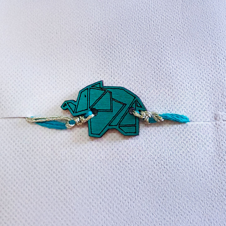 Handmade Blue Elephant Shape Wooden Rakhi With Roli Chawal For Brother - Close-up Front View