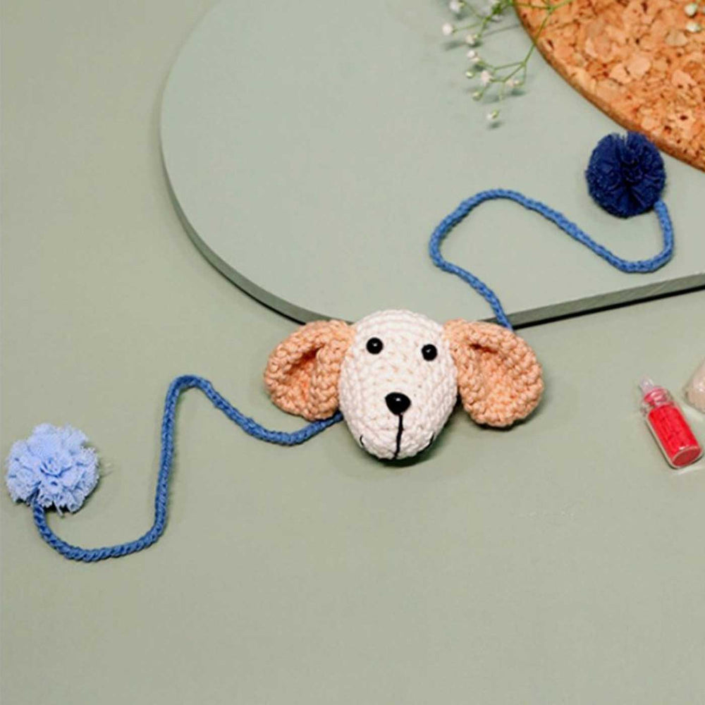 Handmade Crochet Puppy Love Kids Lumba Rakhi With Roli Chawal - Flat Lay with Pom Poms