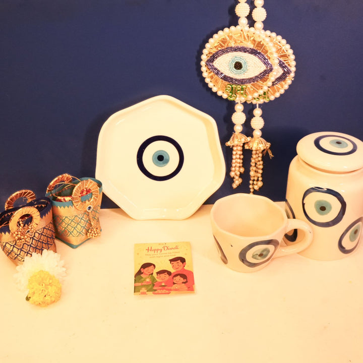 Nazar Suraksha Diwali Gift Hamper | Includes 1 Plate, 1 Mug, 1 Storage Container, 2 Hangings, 2 Dry Fruit Potlis, 1 Diwali Card, 1 Gift Box