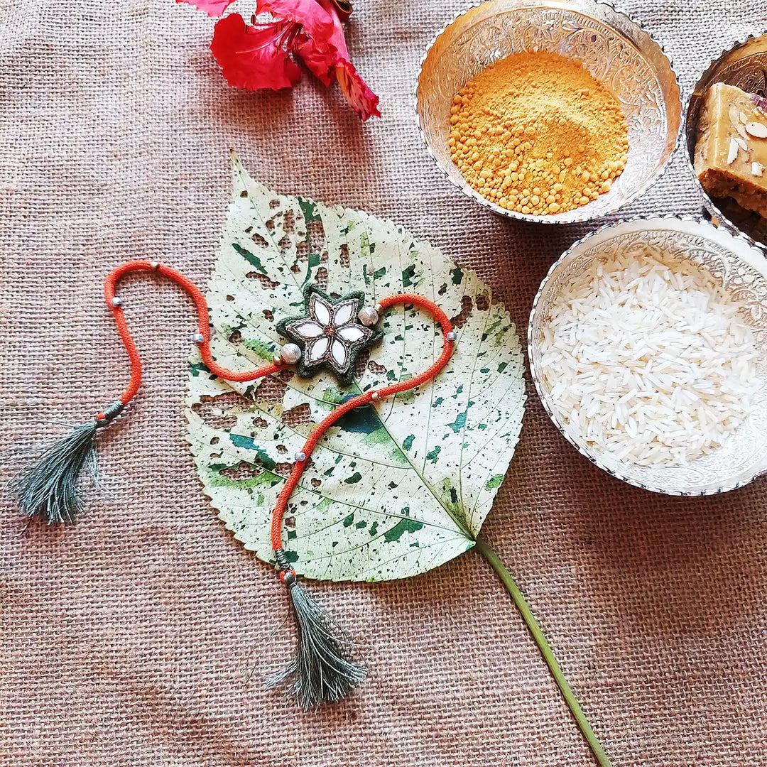 Handmade Mirror Work Flower Rakhi With Roli Chawal - Styled Flat Lay with Accessories (8)