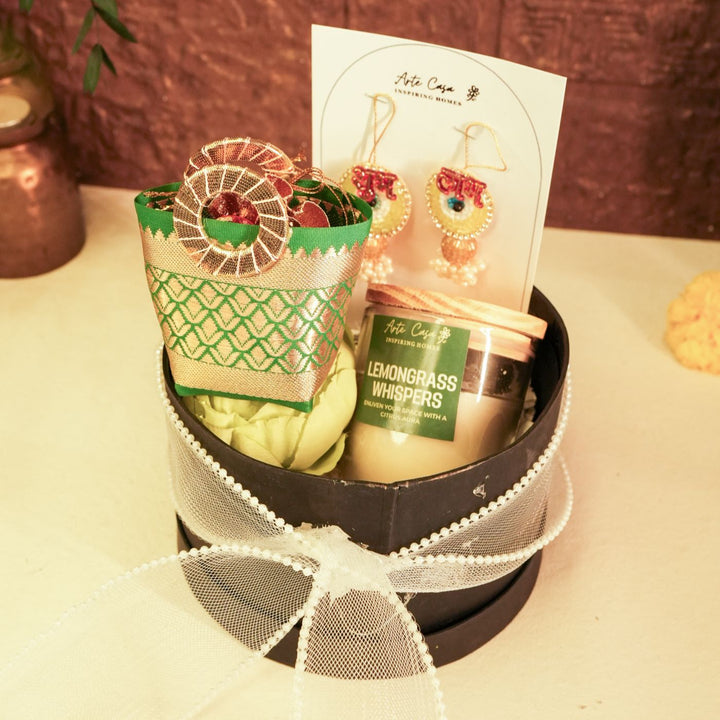 Aura Diwali Gift Hamper | Includes 2 Hangings, 1 Candle, 1 Dry Fruit Potli, 1 Decor Flower, 1 Diwali Card, 1 Round Gift Box