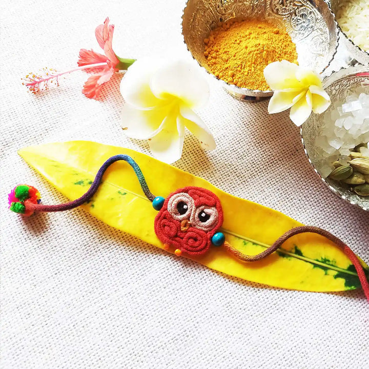 Handmade Dori Work Cute Owl Kids Rakhi With Roli Chawal - Styled Product Display