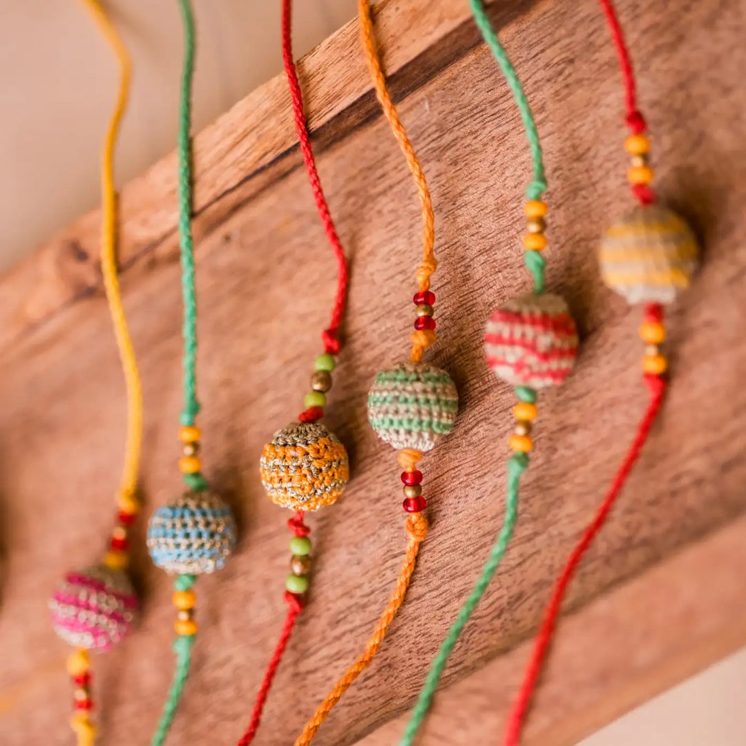 Handmade Crochet Multicolour Lined Suraj Rakhi With Roli Chawal Set Of 6 - Detailed side bead view