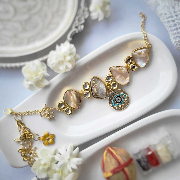 Handmade Evil Eye Design Bracelet Rakhi Hamper With Roli Chawal For Sisters - Flat Lay Display with Background Decor