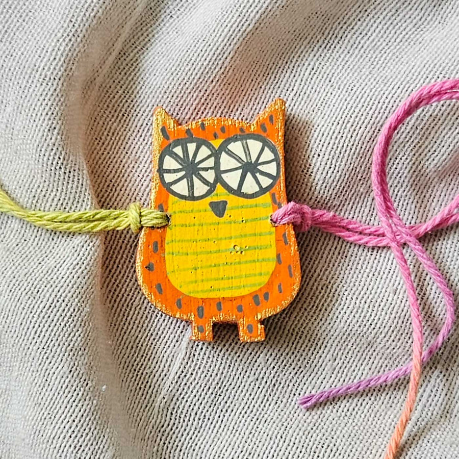 Handpainted Quirky Wooden Rakhi With Roli Chawal - Close-up of Single Owl Bracelet
