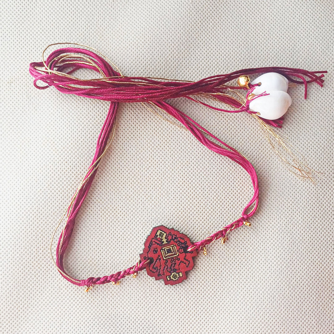 Handmade Red Elephant Ghungroo And Shell Wooden Bhaiya Bhabhi Rakhi With Roli Chawal - Full Product Layout on Surface