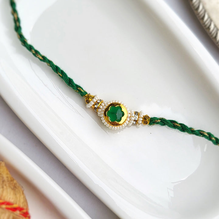 Handcrafted Jadau Kundan Emerald Green Bhai Rakhi with Indian Motif Bhabhi Cuff | Set of 2