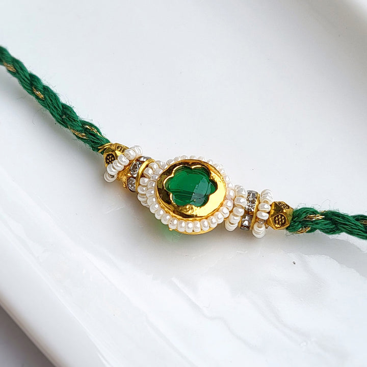 Handcrafted Jadau Kundan Emerald Green Bhai Rakhi with Pearl Bhabhi Bracelet | Set of 2