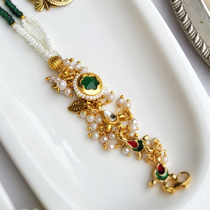 Handcrafted Jadau Kundan Emerald Green Bhai Rakhi with Pearl Bhabhi Bracelet | Set of 2