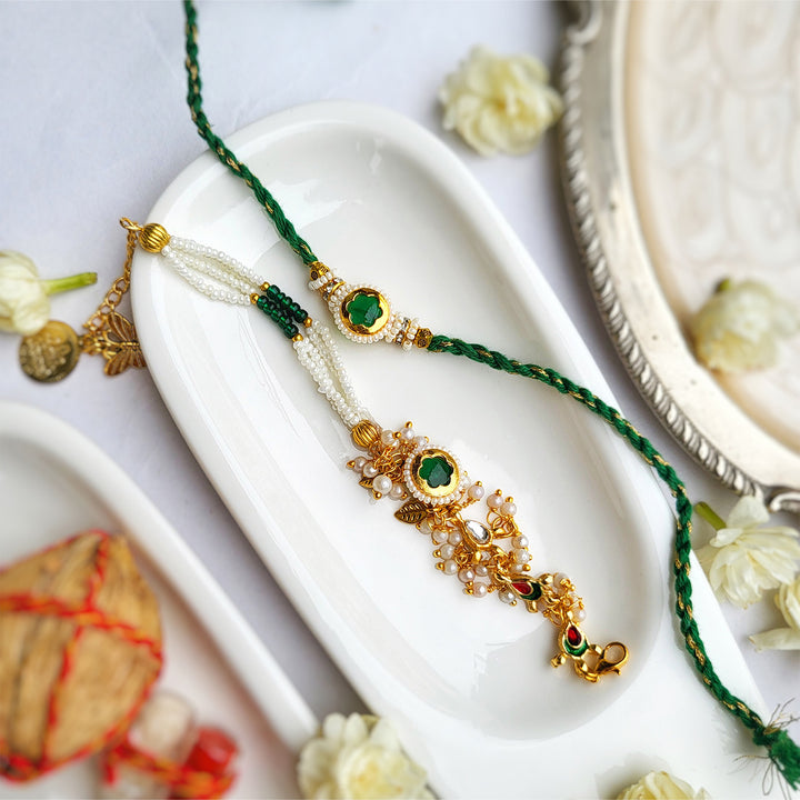 Handcrafted Jadau Kundan Emerald Green Bhai Rakhi with Pearl Bhabhi Bracelet | Set of 2