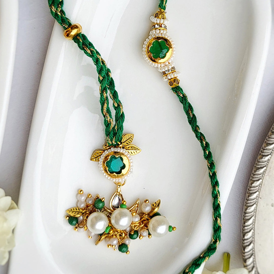 Handcrafted Jadau Kundan Emerald Green Bhai Rakhi with Indian Motif Bhabhi Cuff | Set of 2