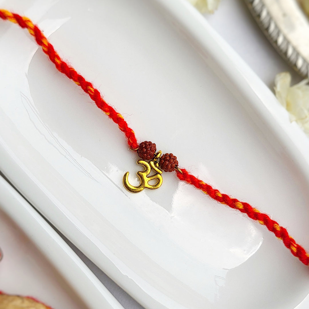 Handcrafted Brass-Cut Om Double Rudraksha Rakhi With Roli Chawal For Brother