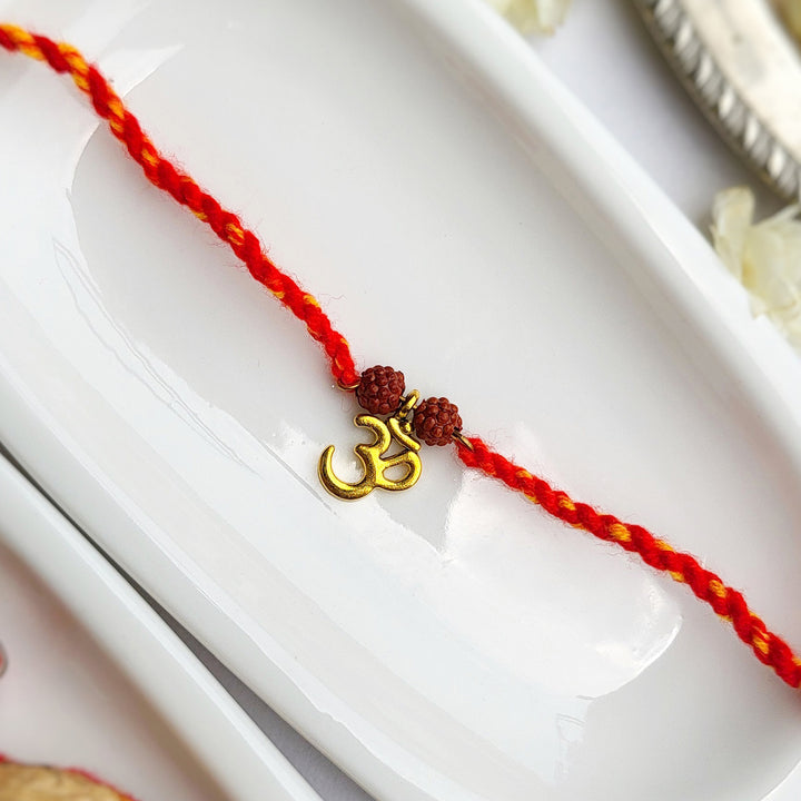 Handcrafted Brass-Cut Om Double Rudraksha Rakhi With Roli Chawal For Brother
