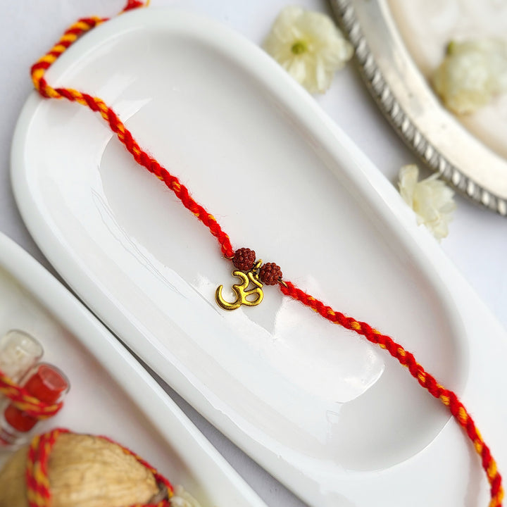 Handcrafted Brass-Cut Om Double Rudraksha Rakhi With Roli Chawal For Brother