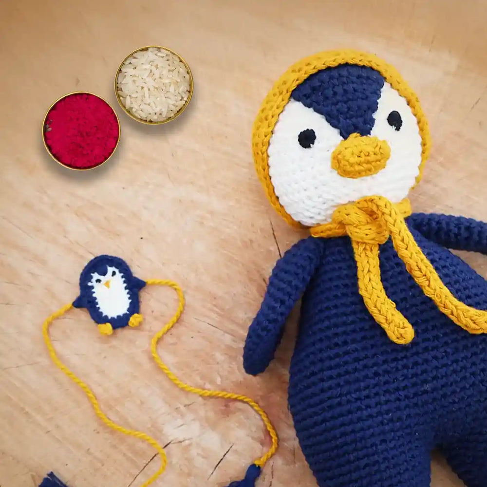 Handmade Crochet Penguin Theme Kids Rakhi And Toy Combo With Roli Chawal Set Of 2 - Accessory and Front Detail Close-up