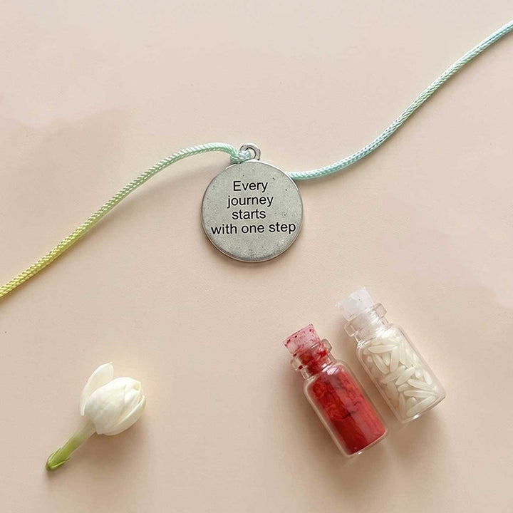 Engraved "Every Journey Starts With One Step" Quote Metal Charm Rakhi With Roli Chawal for Brother