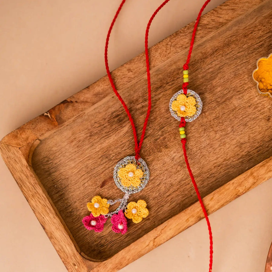 Handmade Crochet Golden Daisy Bhaiya Bhabhi Rakhi With Roli Chawal Set Of 2 - Flat Lay of Two Items