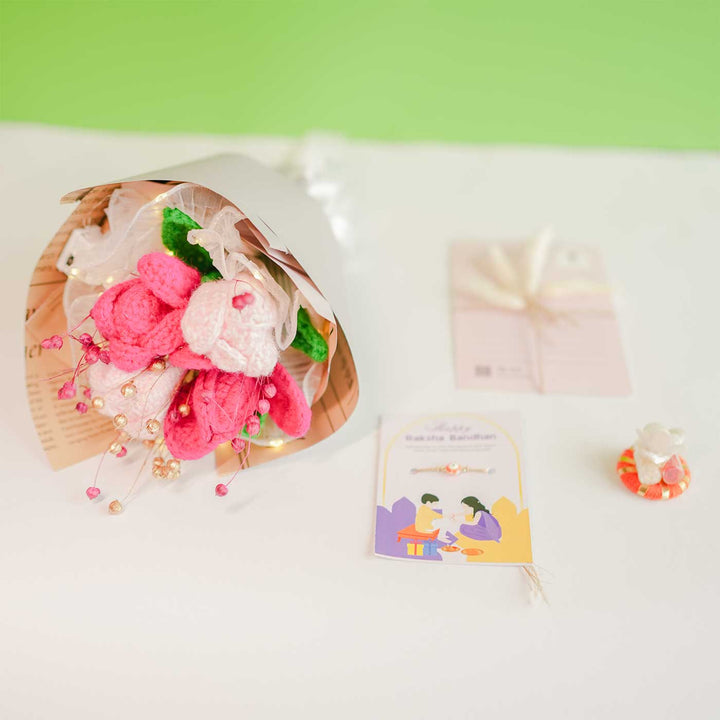 Personalized Handmade Crochet Pretty Pansy Rakhi Hamper Includes 1 Crochet Flower Bunch 1 Message Card And 1 Rakhi And Roli Chawal - Flat Lay with Accessories