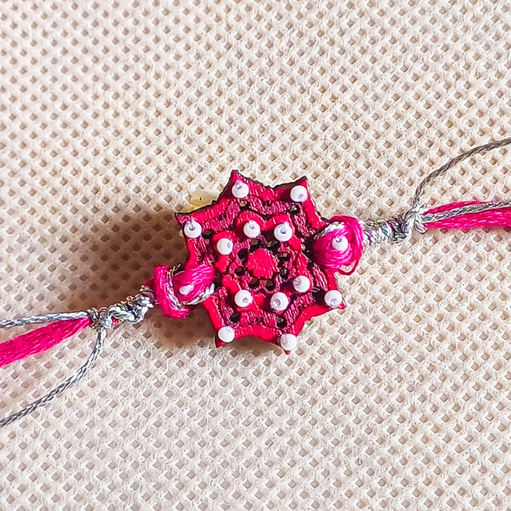Handmade Pink Star Design Beads Wooden Rakhi With Roli Chawal For Brother - Close-up of Central Embellishment