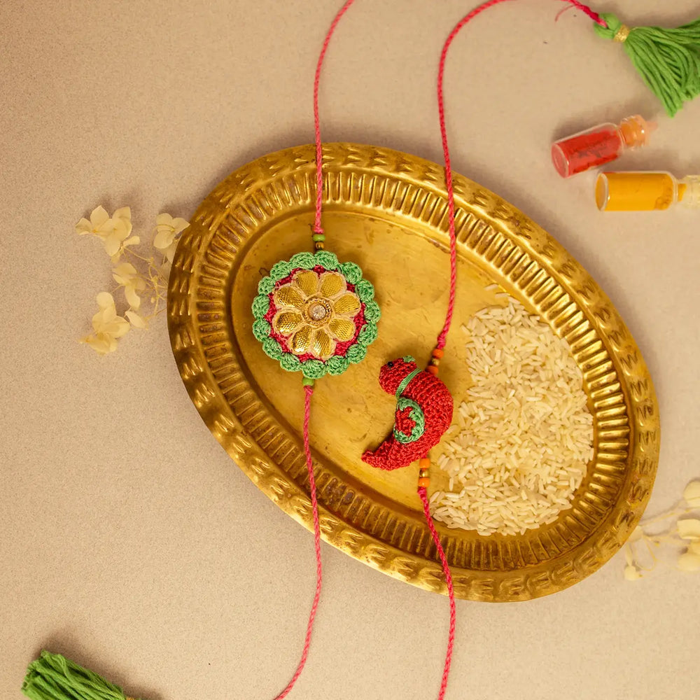 Handmade Crochet Bird And Flower Rakhi With Roli Chawal Set Of 2 - Top View with Decorative Items