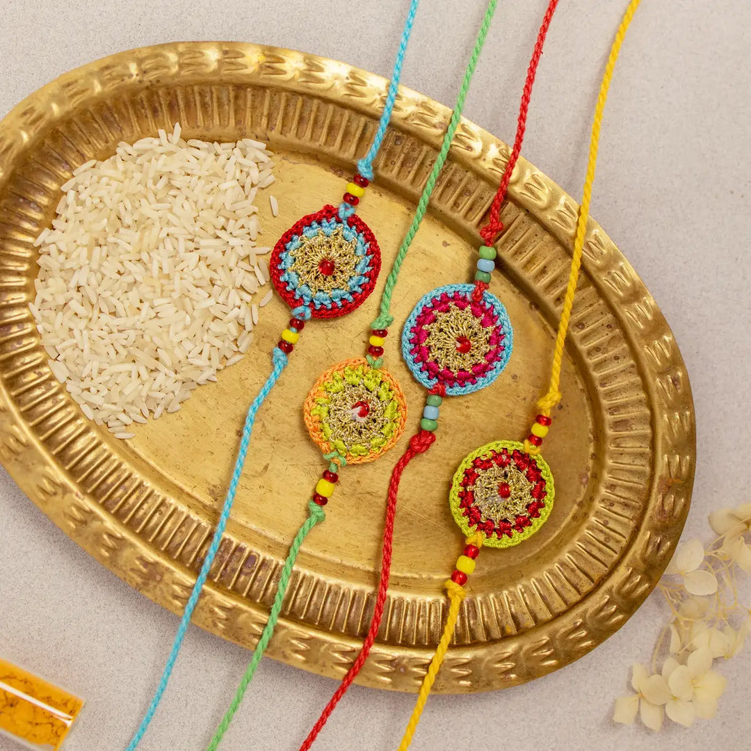 Handmade Crochet Multicolour Mandala Rakhi With Roli Chawal Set Of 4 - Angled View Showing Full Length