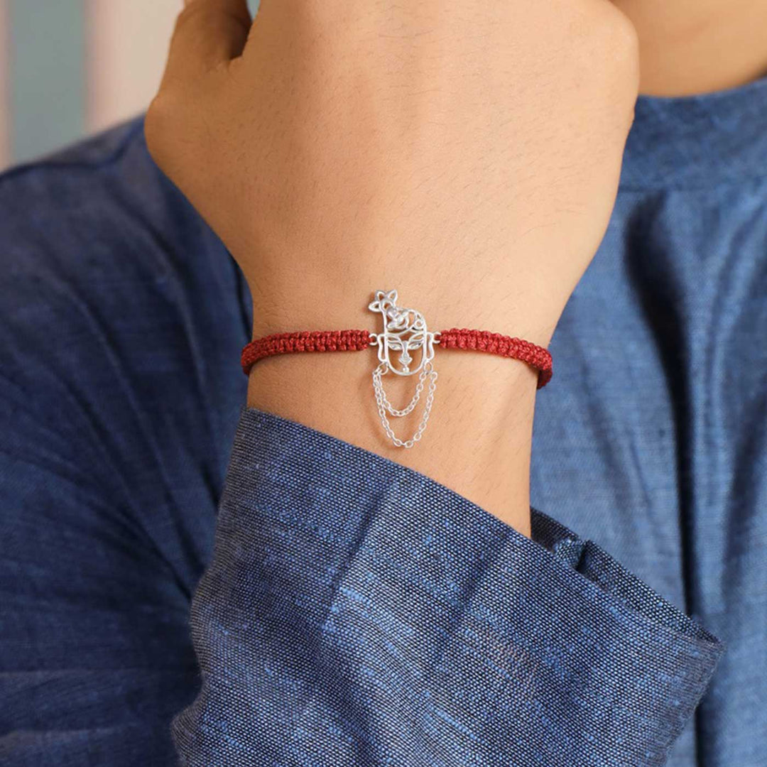 Handmade Krishna Design Religious Silver Rakhi For Brother - On Wrist Model View